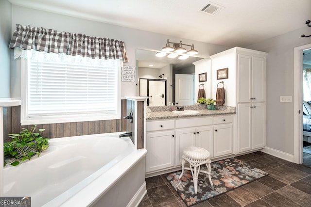 99 Mcmillian Ct, Winder, GA 30680 - bathroom featuring visible vents, a garden tub, a stall shower, and vanity