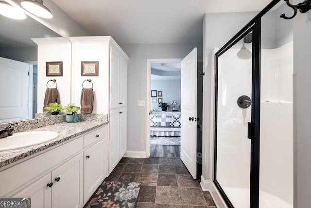 99 Mcmillian Ct, Winder, GA 30680 - ensuite bathroom featuring vanity, ensuite bath, baseboards, and a shower stall