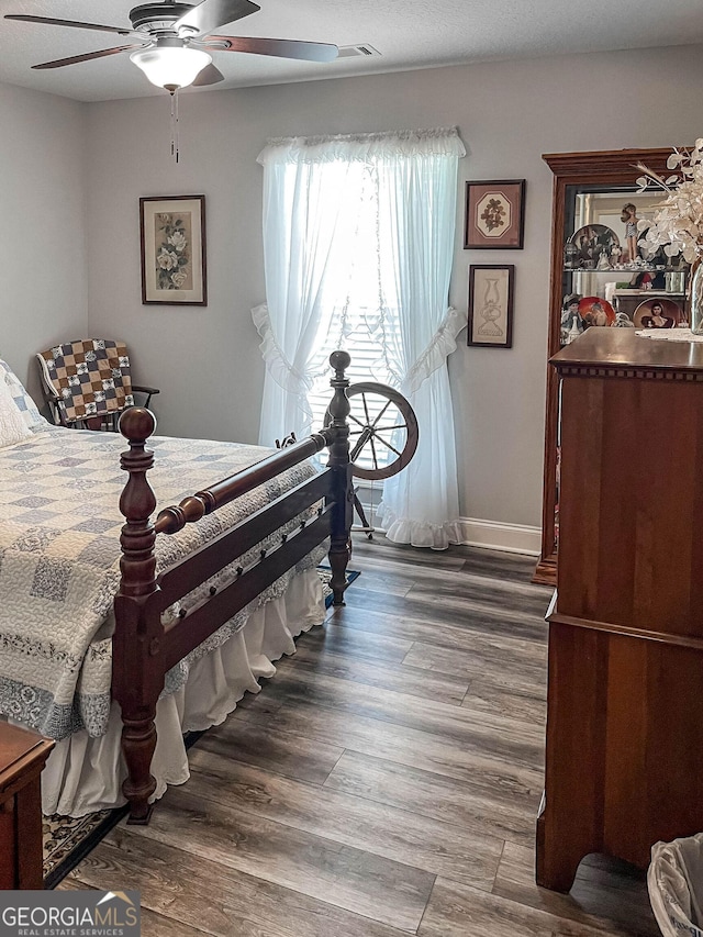 99 Mcmillian Ct, Winder, GA 30680 - bedroom with baseboards, a ceiling fan, and wood finished floors