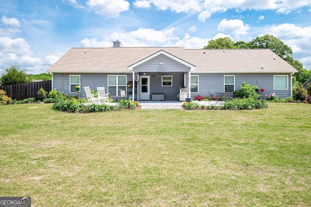 99 Mcmillian Ct, Winder, GA 30680 - back of property featuring a chimney, fence, a patio area, and a lawn