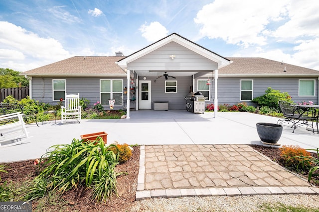 99 Mcmillian Ct, Winder, GA 30680 - back of property featuring fence, a shingled roof, a ceiling fan, and a patio