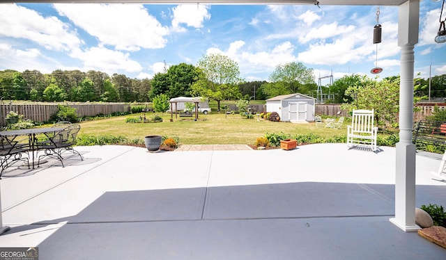 99 Mcmillian Ct, Winder, GA 30680 - view of patio featuring an outdoor structure, fence, a storage shed, and a gazebo