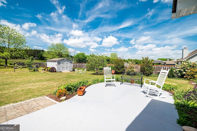 99 Mcmillian Ct, Winder, GA 30680 - view of patio with a fenced backyard, an outbuilding, and a shed