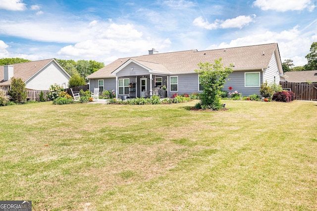 99 Mcmillian Ct, Winder, GA 30680 - back of property with fence, a lawn, and roof with shingles