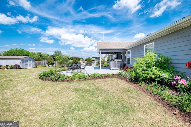 99 Mcmillian Ct, Winder, GA 30680 - view of yard with fence, a shed, a patio area, ceiling fan, and an outdoor structure
