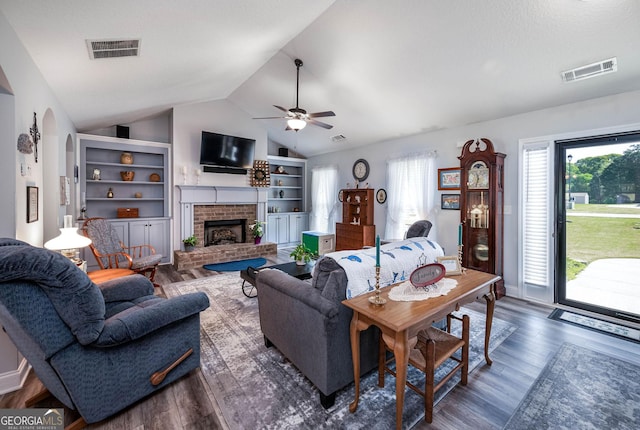 99 Mcmillian Ct, Winder, GA 30680 - living room with wood finished floors, visible vents, and a brick fireplace