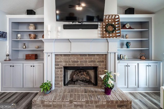 99 Mcmillian Ct, Winder, GA 30680 - interior space with wood finished floors, a brick fireplace, and built in shelves
