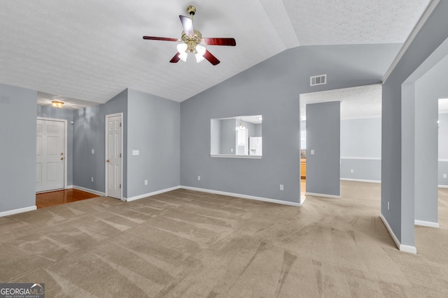 1220 Skipping Rock Ln SW, Grayson, GA 30017 - unfurnished living room with baseboards, ceiling fan, light carpet, and lofted ceiling
