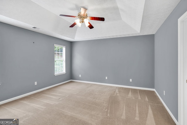 1220 Skipping Rock Ln SW, Grayson, GA 30017 - carpeted spare room featuring visible vents, baseboards, ceiling fan, a textured ceiling, and a raised ceiling