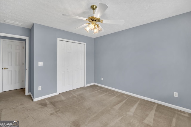 1220 Skipping Rock Ln SW, Grayson, GA 30017 - unfurnished bedroom with carpet floors, visible vents, a closet, baseboards, and a textured ceiling