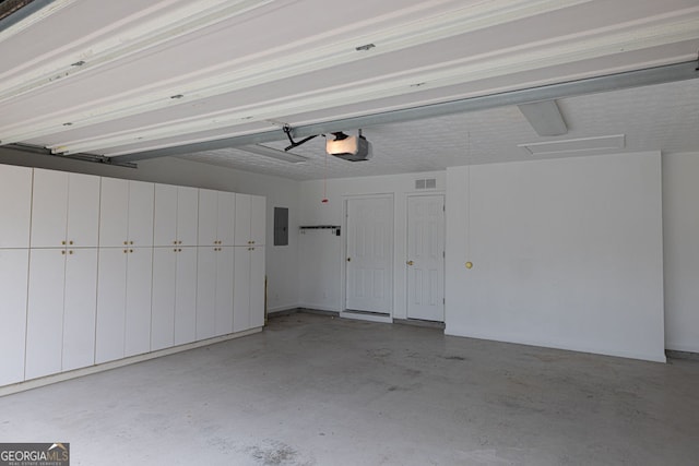 1220 Skipping Rock Ln SW, Grayson, GA 30017 - garage featuring visible vents, a garage door opener, and electric panel