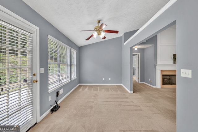 1220 Skipping Rock Ln SW, Grayson, GA 30017 - interior space with a fireplace, a textured ceiling, carpet, a ceiling fan, and baseboards