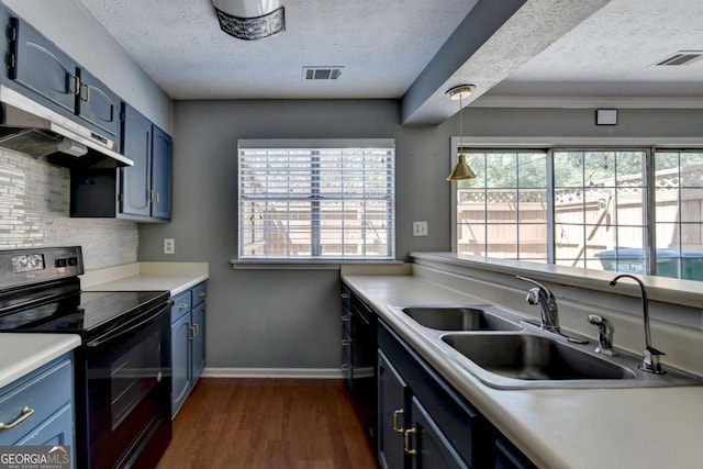 kitchen with black / electric stove, visible vents, a sink, a textured ceiling, and blue cabinetry