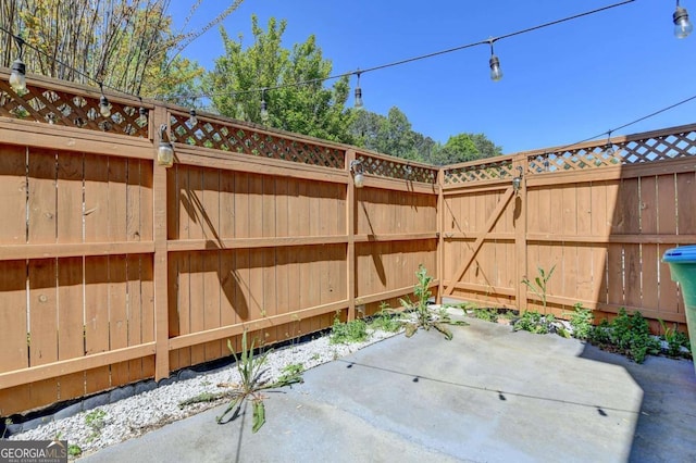 view of patio featuring fence