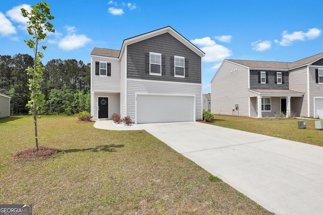 view of front of home featuring an attached garage, driveway, and a front lawn