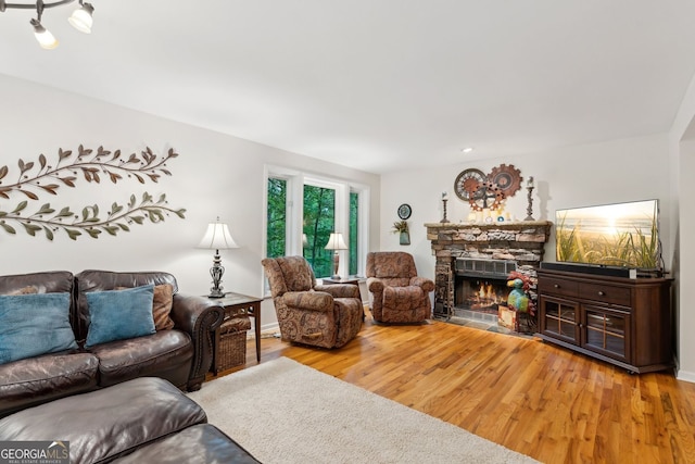 4761 Gateway Ln, Flowery Branch, GA 30542 - living room with a stone fireplace and wood finished floors