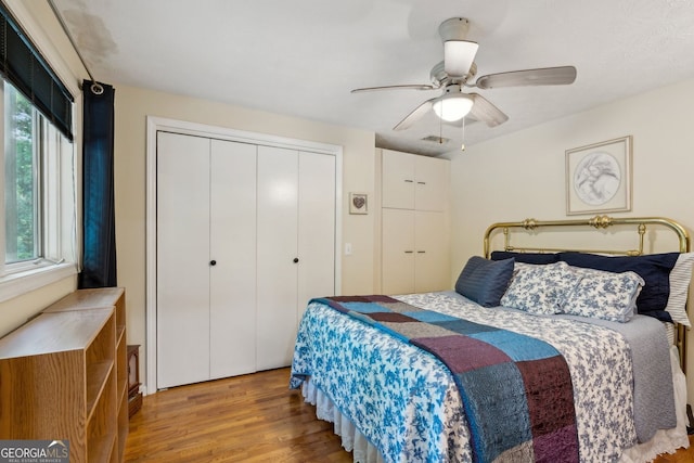 4761 Gateway Ln, Flowery Branch, GA 30542 - bedroom with wood finished floors, a ceiling fan, and a closet