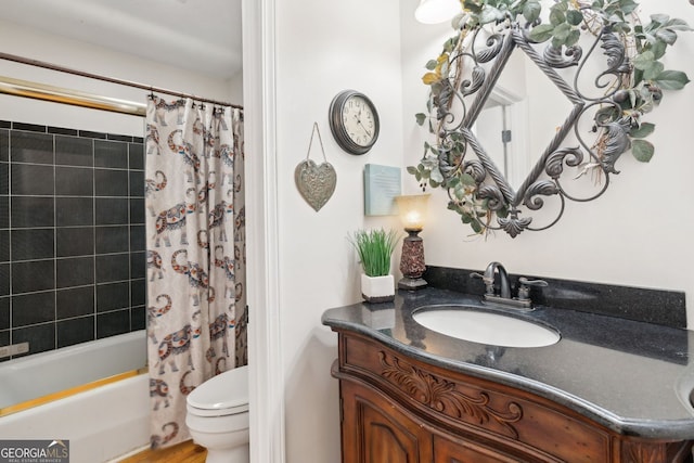 bathroom featuring shower / tub combo, vanity, and toilet