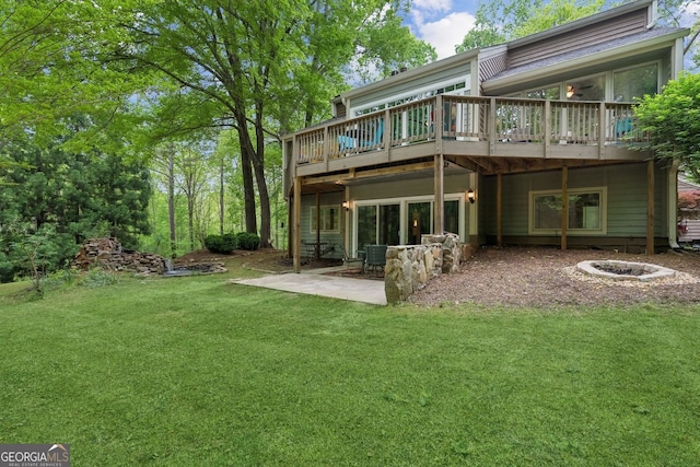 4761 Gateway Ln, Flowery Branch, GA 30542 - rear view of house with a yard, a deck, a patio area, and an outdoor fire pit