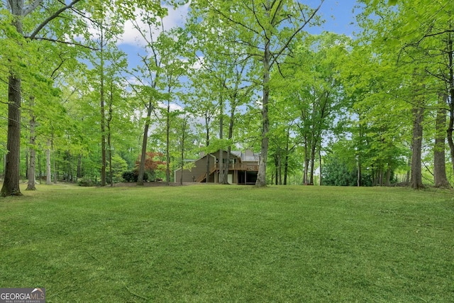 4761 Gateway Ln, Flowery Branch, GA 30542 - view of grassy yard featuring stairs and a wooden deck