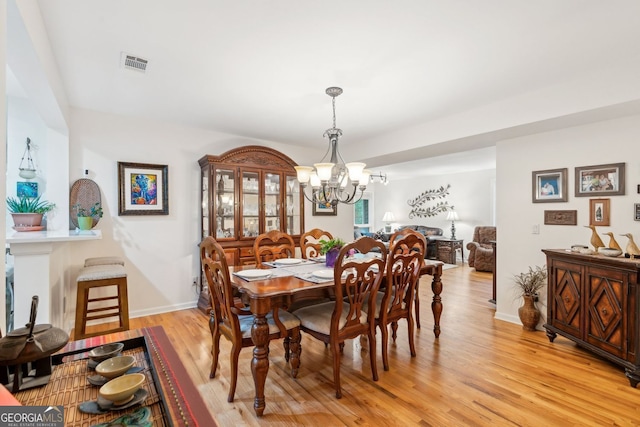 4761 Gateway Ln, Flowery Branch, GA 30542 - dining area with a chandelier and light wood-style flooring