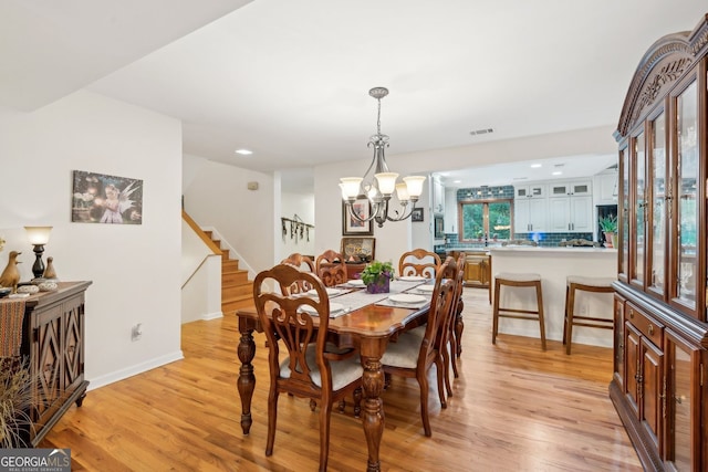 4761 Gateway Ln, Flowery Branch, GA 30542 - dining space featuring light wood finished floors, stairs, a chandelier, and recessed lighting