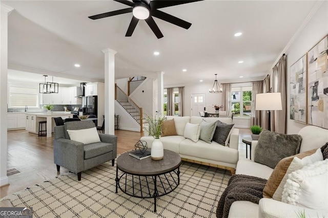 2553 Creekwood Ter, Decatur, GA 30030 - living room with decorative columns, a ceiling fan, stairs, a chandelier, and recessed lighting