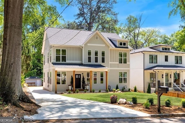 2553 Creekwood Ter, Decatur, GA 30030 - modern inspired farmhouse featuring a porch, an outbuilding, board and batten siding, and a front yard