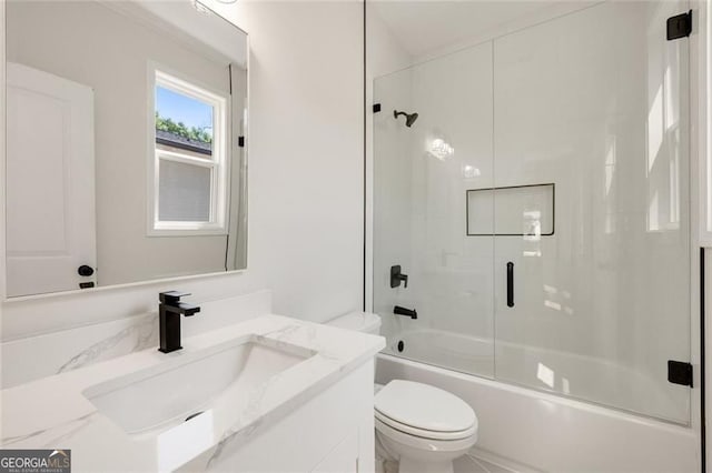 2553 Creekwood Ter, Decatur, GA 30030 - bathroom featuring toilet, vanity, and shower / bath combination with glass door