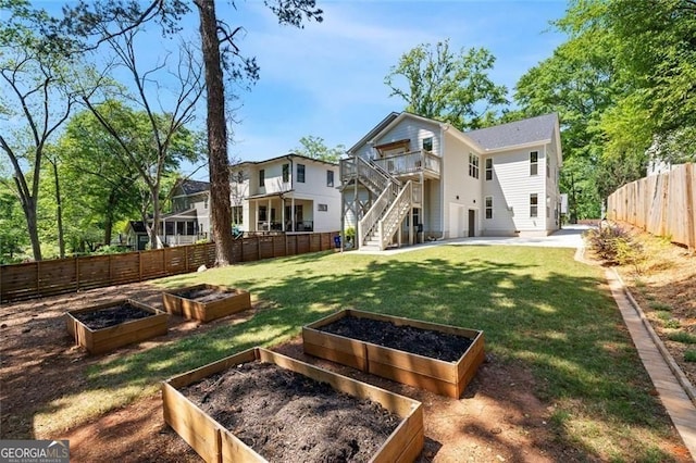 2553 Creekwood Ter, Decatur, GA 30030 - back of house featuring a vegetable garden, a patio area, stairway, and a deck