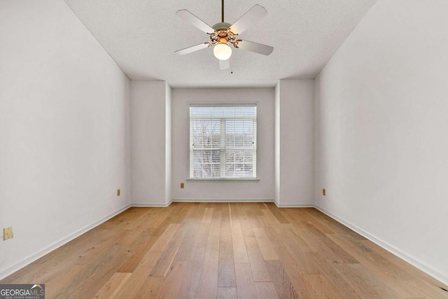 406 Vinings Forest Cir SE, Smyrna, GA 30080 - unfurnished room with light wood finished floors, a ceiling fan, baseboards, and a textured ceiling