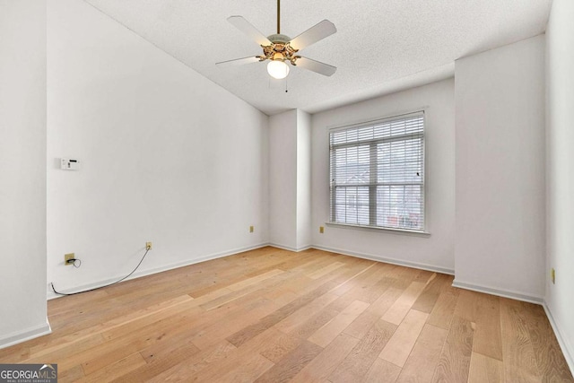 406 Vinings Forest Cir SE, Smyrna, GA 30080 - empty room with ceiling fan, baseboards, a textured ceiling, and light wood-style flooring
