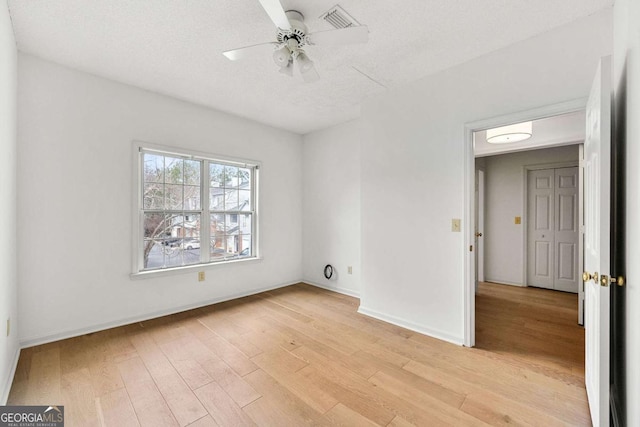 406 Vinings Forest Cir SE, Smyrna, GA 30080 - spare room with visible vents, a ceiling fan, baseboards, and light wood-style floors