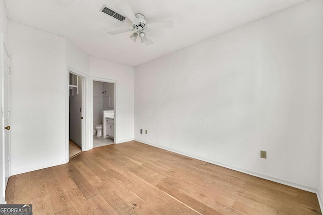 406 Vinings Forest Cir SE, Smyrna, GA 30080 - unfurnished bedroom featuring light wood-type flooring, baseboards, visible vents, ceiling fan, and connected bathroom