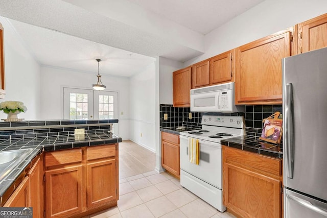 406 Vinings Forest Cir SE, Smyrna, GA 30080 - kitchen with tile countertops, light tile patterned floors, white appliances, pendant lighting, and tasteful backsplash