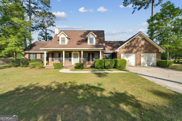 cape cod house featuring brick siding, an attached garage, a front yard, and covered porch