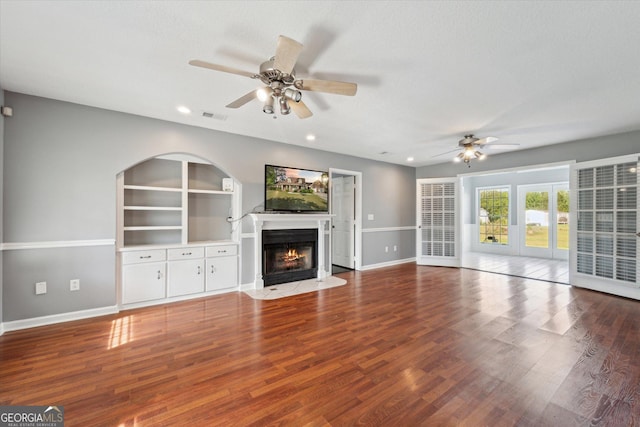 unfurnished living room featuring a fireplace with flush hearth, recessed lighting, wood finished floors, visible vents, and a ceiling fan