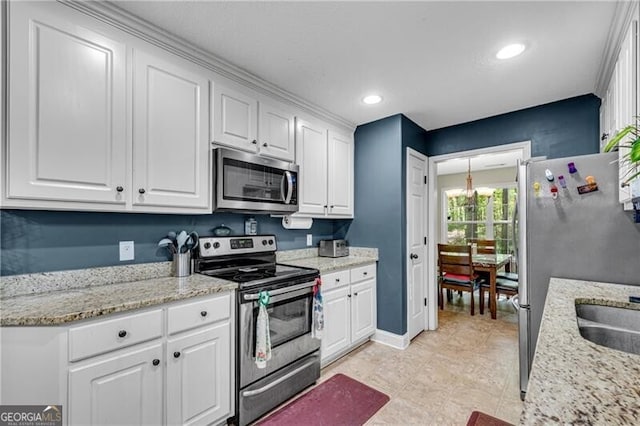 12 Mulberry Rd, Winder, GA 30680 - kitchen featuring appliances with stainless steel finishes, white cabinetry, recessed lighting, and light stone countertops