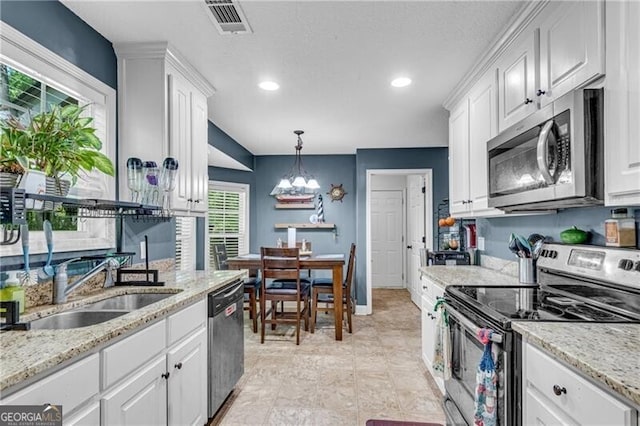 12 Mulberry Rd, Winder, GA 30680 - kitchen featuring appliances with stainless steel finishes, white cabinets, a chandelier, pendant lighting, and recessed lighting