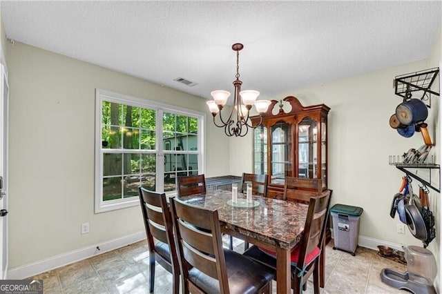 12 Mulberry Rd, Winder, GA 30680 - dining space with a chandelier and a textured ceiling