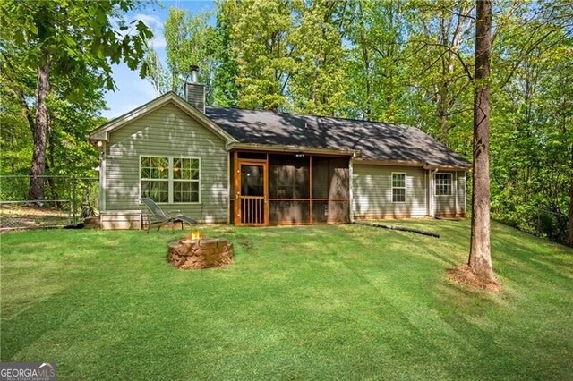12 Mulberry Rd, Winder, GA 30680 - view of front of home with a chimney, a sunroom, and a fire pit
