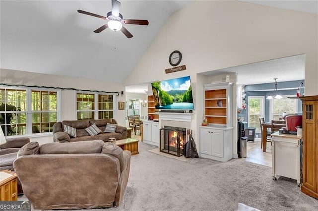 12 Mulberry Rd, Winder, GA 30680 - living room featuring high vaulted ceiling, a ceiling fan, a fireplace with flush hearth, and light carpet