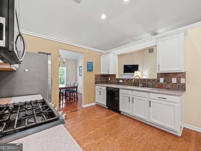 2402 Jasmine Glen Dr, Buford, GA 30519 - kitchen featuring tasteful backsplash, a sink, light wood-style floors, white cabinets, and appliances with stainless steel finishes