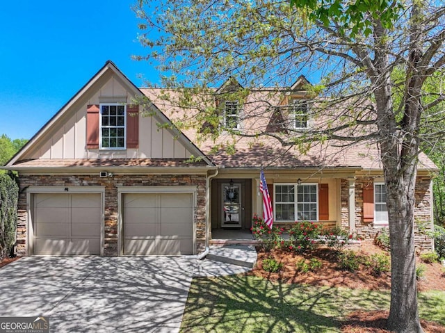 2402 Jasmine Glen Dr, Buford, GA 30519 - view of front of home featuring driveway, stone siding, board and batten siding, and a garage