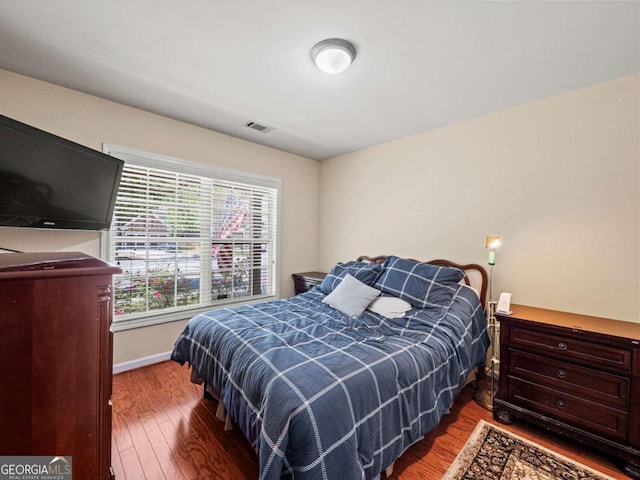 2402 Jasmine Glen Dr, Buford, GA 30519 - bedroom featuring baseboards, wood finished floors, and visible vents