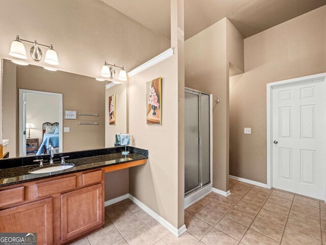 2402 Jasmine Glen Dr, Buford, GA 30519 - bathroom with a shower stall, tile patterned flooring, vanity, ensuite bath, and baseboards