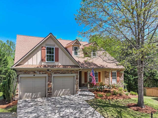 2402 Jasmine Glen Dr, Buford, GA 30519 - craftsman house with fence, a shingled roof, board and batten siding, driveway, and stone siding