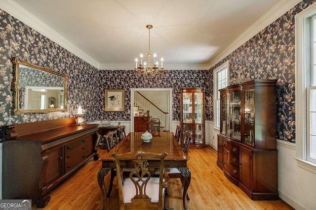 835 Timothy Rd, Athens, GA 30606 - dining room featuring wallpapered walls, light wood finished floors, stairs, and an inviting chandelier