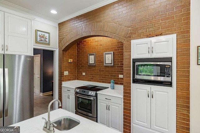 835 Timothy Rd, Athens, GA 30606 - kitchen featuring white cabinets, stainless steel appliances, light countertops, ornamental molding, and a sink