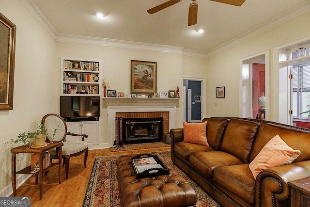 835 Timothy Rd, Athens, GA 30606 - living room with a brick fireplace, wood finished floors, ceiling fan, and crown molding